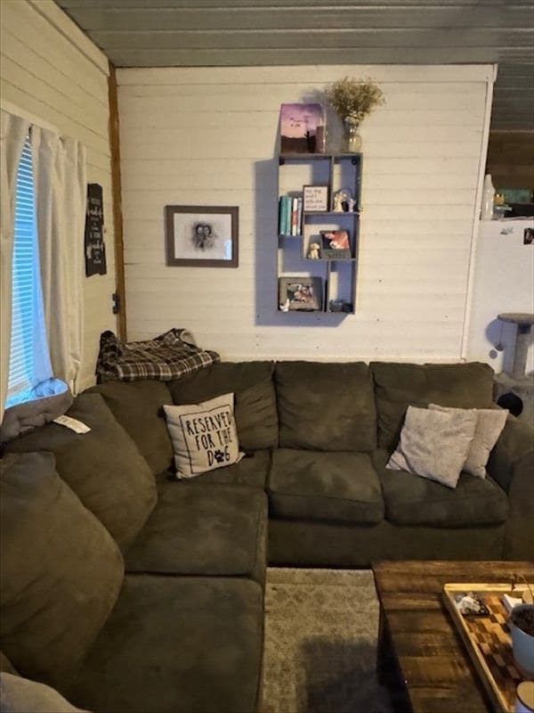 living area featuring wooden walls