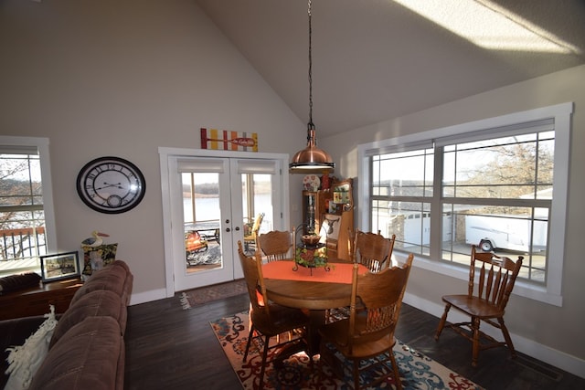 dining room featuring high vaulted ceiling, dark hardwood / wood-style flooring, french doors, and a healthy amount of sunlight