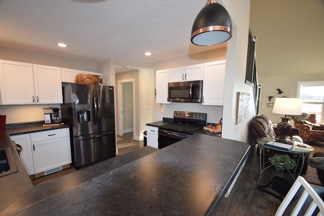 kitchen featuring range with electric stovetop, black fridge with ice dispenser, and white cabinetry