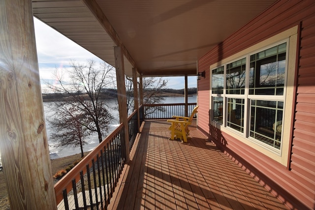 wooden terrace featuring a water view