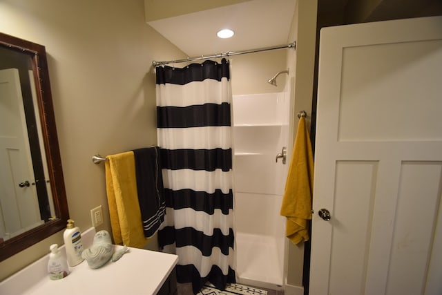 bathroom featuring curtained shower and vanity