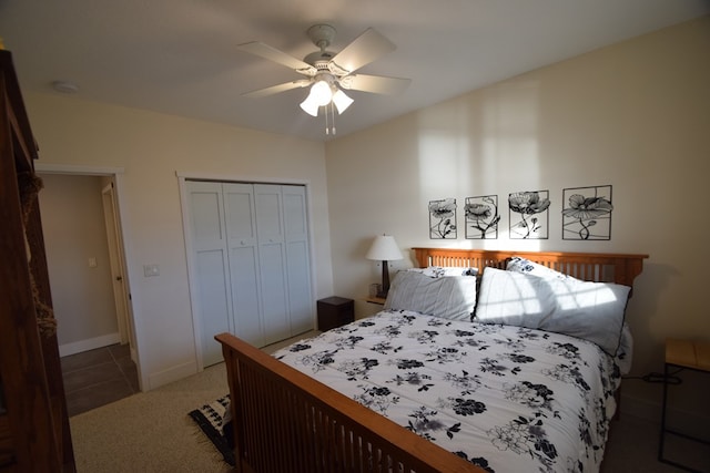 bedroom with ceiling fan, a closet, and dark colored carpet