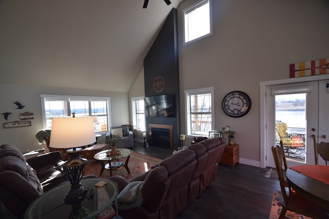 living room featuring a wealth of natural light, dark hardwood / wood-style flooring, and high vaulted ceiling