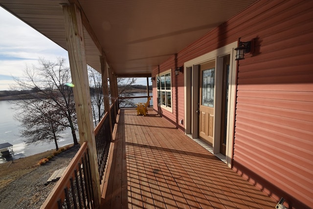 wooden deck featuring a water view