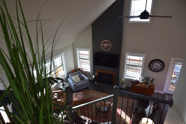 living room featuring ceiling fan and high vaulted ceiling