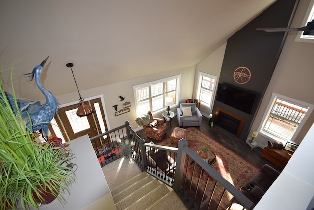 living room with high vaulted ceiling