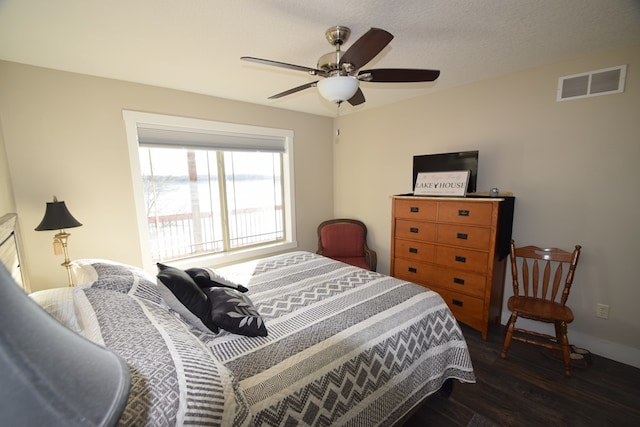 bedroom with ceiling fan and dark hardwood / wood-style floors