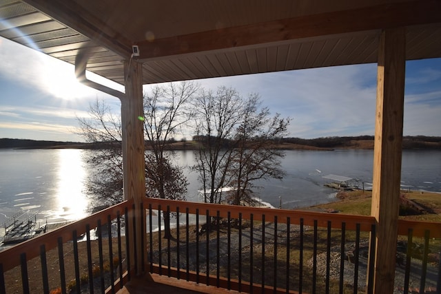 wooden terrace featuring a water view