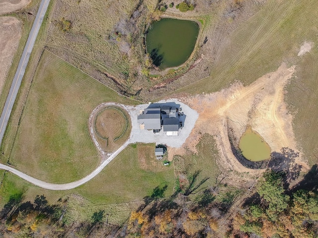 drone / aerial view with a rural view and a water view