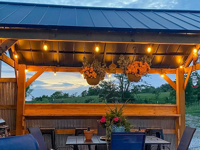 deck at dusk featuring a bar