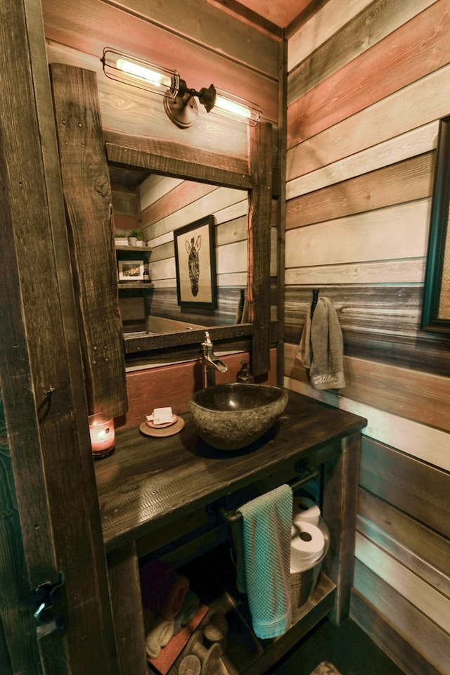 bathroom with wooden walls and vanity