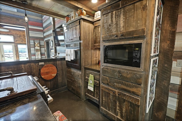 kitchen with dark brown cabinets, wooden walls, and black appliances