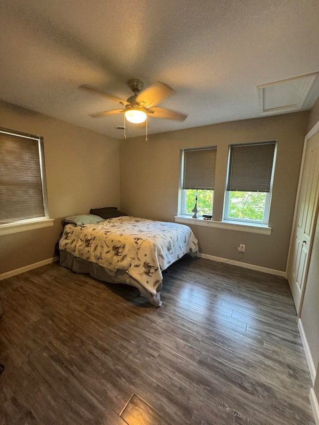 113 Elm St, Milan, MO 63556 - bedroom featuring baseboards, a textured ceiling, wood finished floors, ceiling fan, and attic access