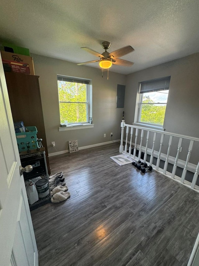 113 Elm St, Milan, MO 63556 - spare room featuring plenty of natural light, a textured ceiling, wood finished floors, and a ceiling fan