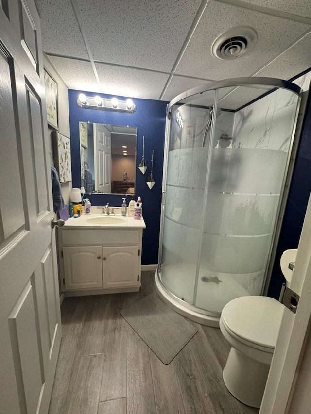 113 Elm St, Milan, MO 63556 - full bath with wood finished floors, vanity, a shower stall, a drop ceiling, and toilet