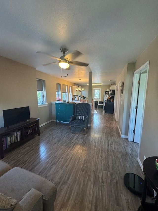 113 Elm St, Milan, MO 63556 - living room featuring plenty of natural light, dark wood-style floors, a textured ceiling, baseboards, and ceiling fan