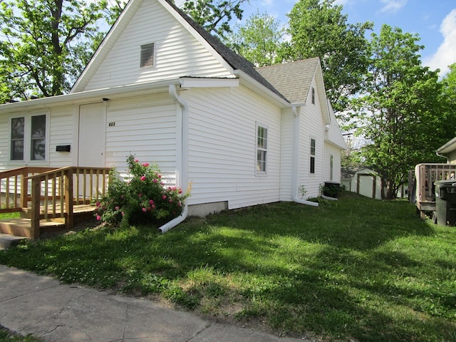 403 E Cottonwood, Kirksville, MO 63501 - view of property exterior featuring a storage unit, a yard, an outbuilding, and roof with shingles