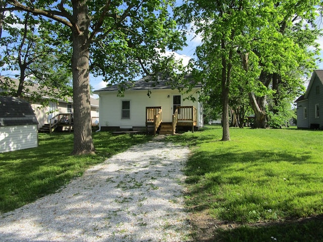 403 E Cottonwood, Kirksville, MO 63501 - view of front of property with a front yard, a deck, and an outbuilding