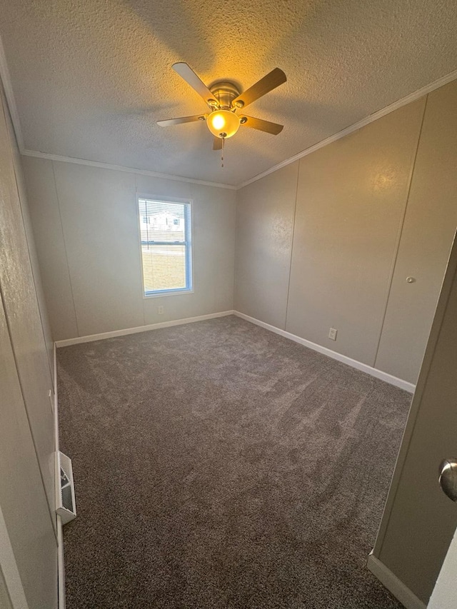 carpeted empty room with crown molding, a ceiling fan, and a textured ceiling