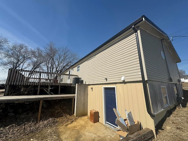 view of property exterior featuring cooling unit and a deck