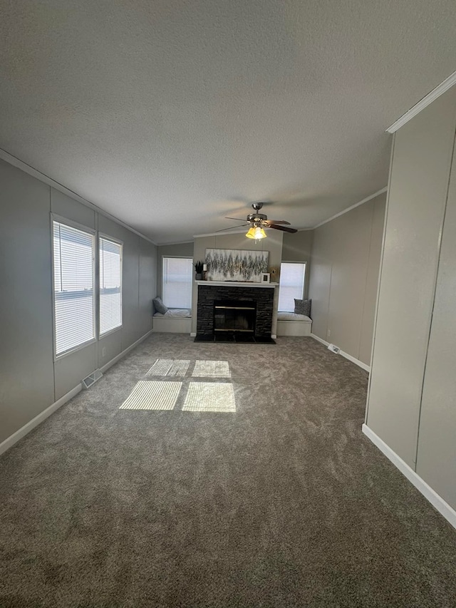 unfurnished living room featuring visible vents, a fireplace with flush hearth, a healthy amount of sunlight, and ornamental molding