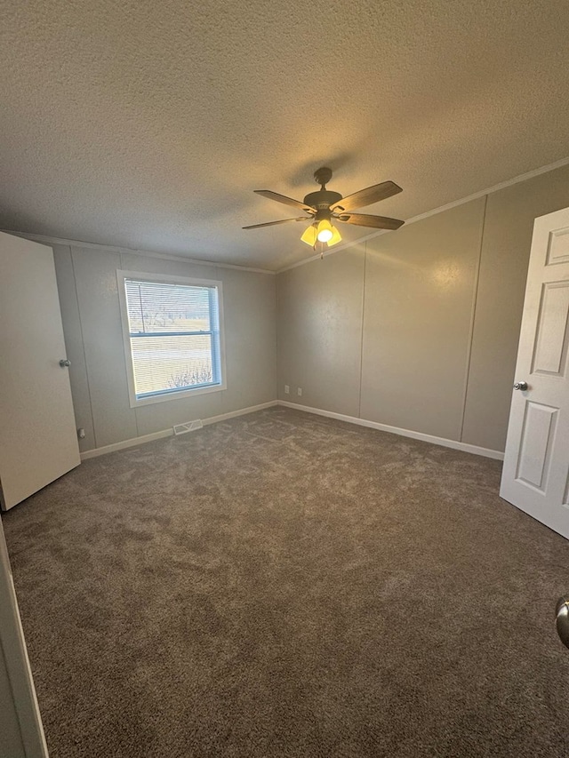 unfurnished bedroom featuring crown molding, visible vents, carpet floors, and ceiling fan