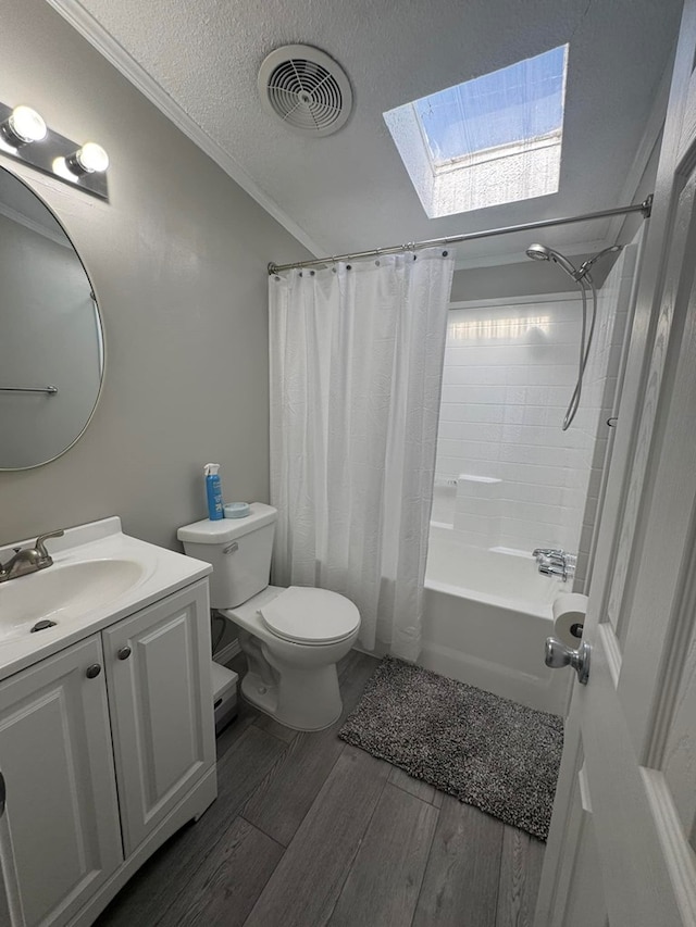 full bath with vanity, wood finished floors, visible vents, a textured ceiling, and toilet