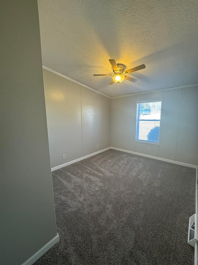 empty room featuring dark carpet, baseboards, crown molding, and ceiling fan