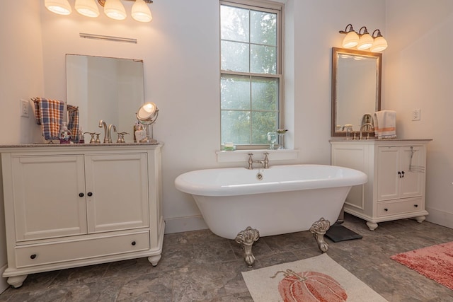 full bath with a soaking tub, vanity, and baseboards