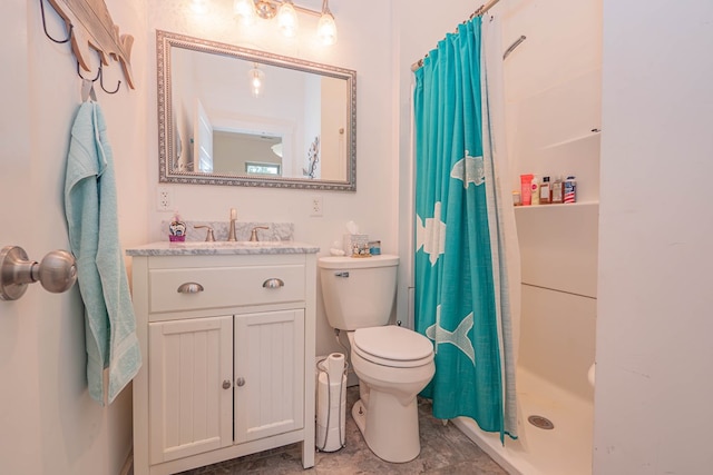 full bathroom featuring toilet, a stall shower, and vanity