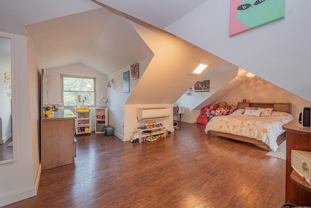 bedroom with vaulted ceiling, baseboards, and wood finished floors