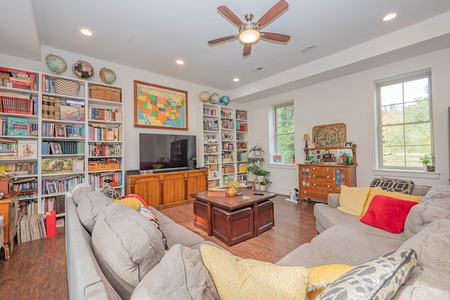 living area with a ceiling fan, recessed lighting, visible vents, and wood finished floors