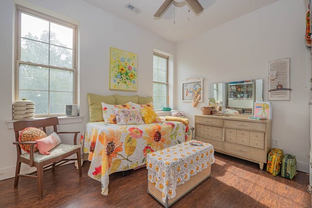 bedroom with wood finished floors, visible vents, and a ceiling fan