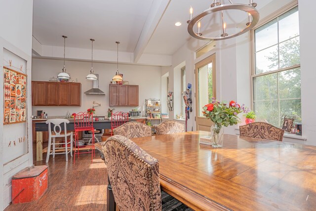 dining area featuring dark wood-type flooring, beamed ceiling, recessed lighting, and a notable chandelier