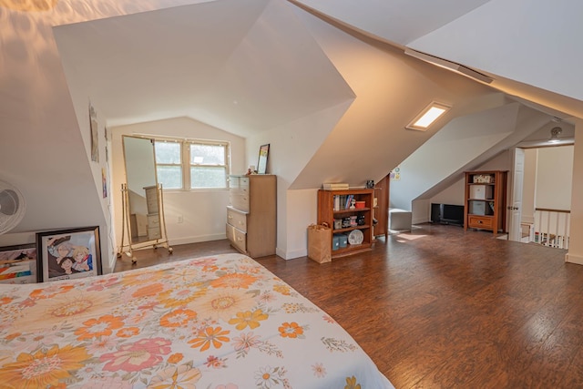 bedroom with vaulted ceiling and wood finished floors