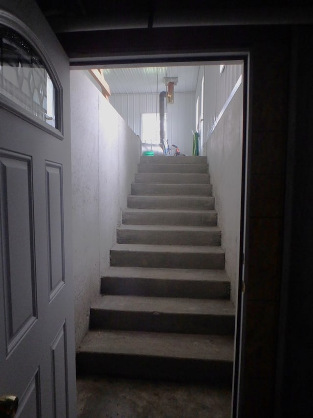 stairway with concrete flooring