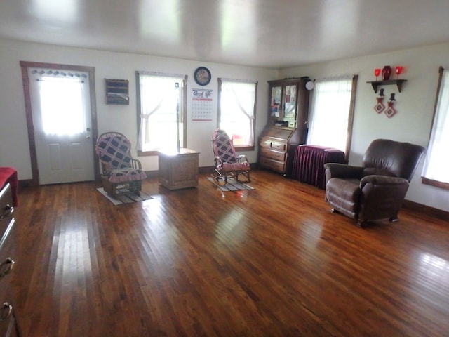 living room featuring plenty of natural light, dark hardwood / wood-style floors, and radiator heating unit