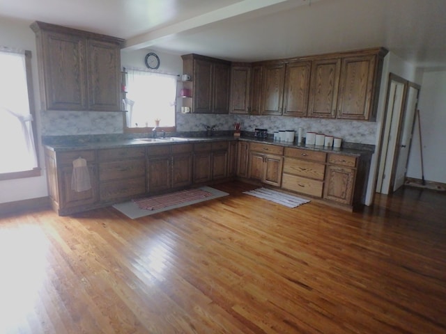 kitchen with backsplash and light hardwood / wood-style floors