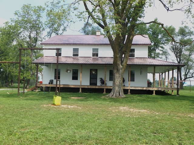 back of house with a yard and a porch