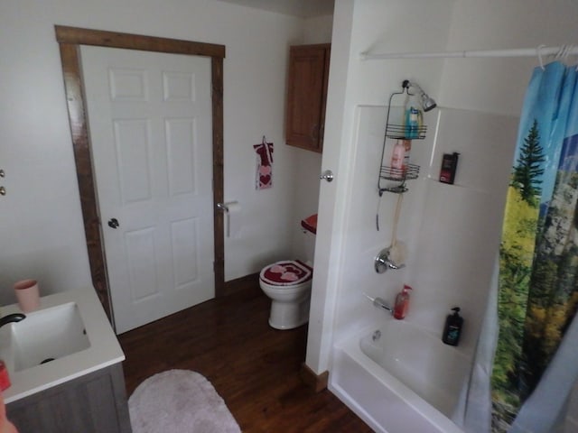 full bathroom featuring hardwood / wood-style floors, shower / bath combo, toilet, and vanity