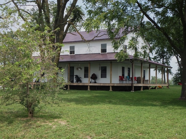 rear view of house with a yard