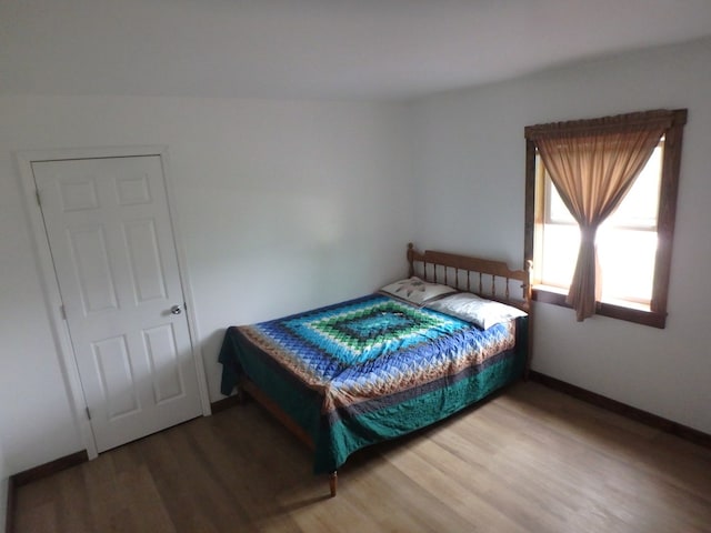 bedroom with wood-type flooring