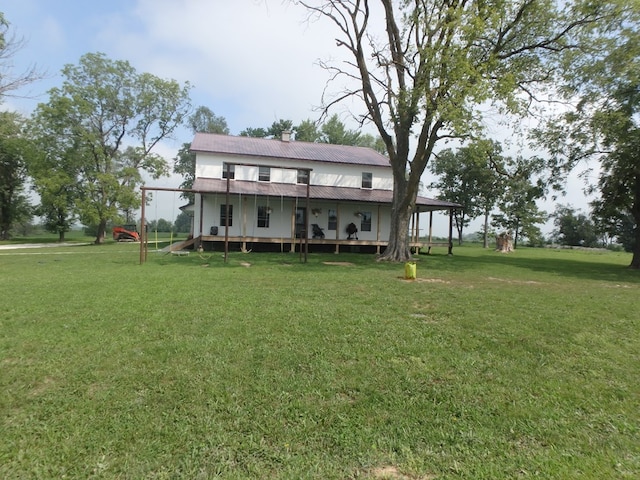 back of house with a lawn