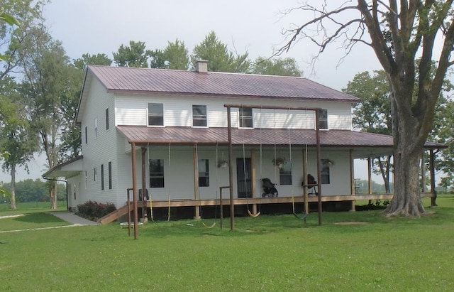 rear view of property with a lawn and a porch