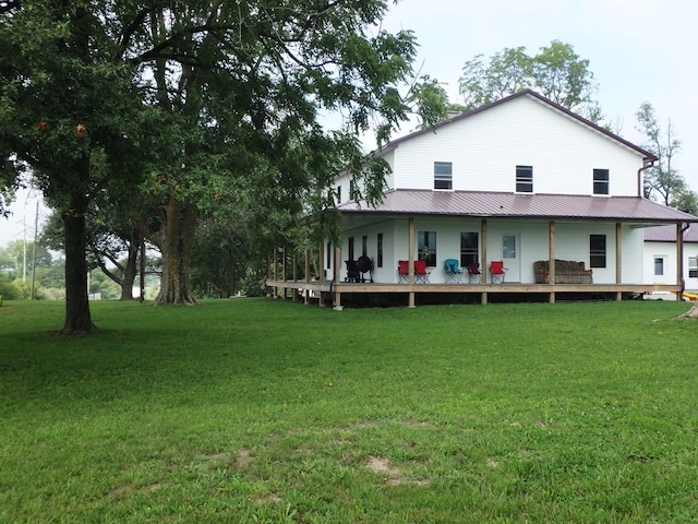 rear view of house featuring a lawn