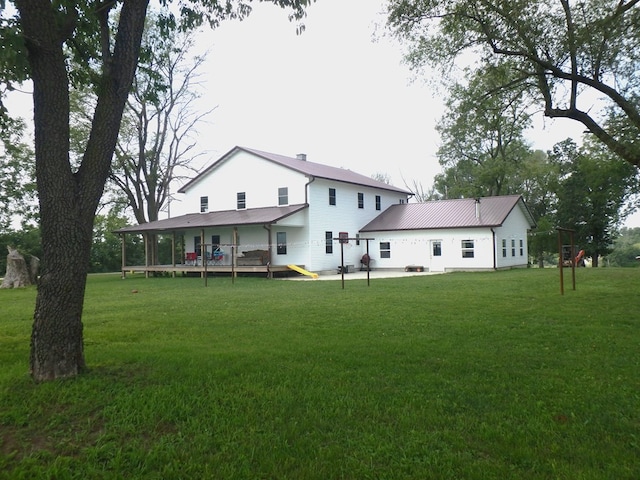 rear view of property featuring a yard