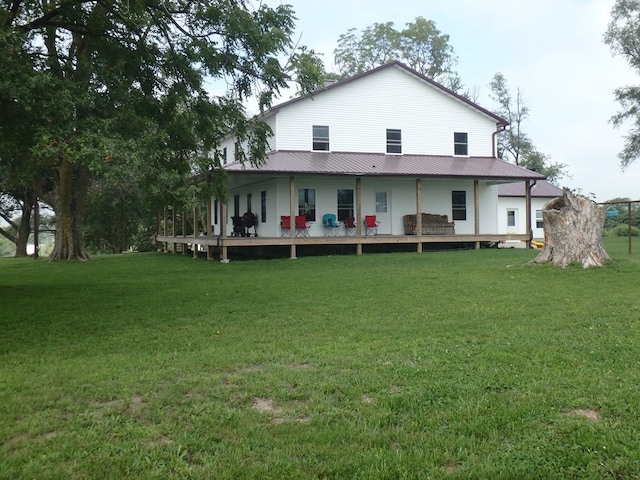 back of house with a yard and a deck