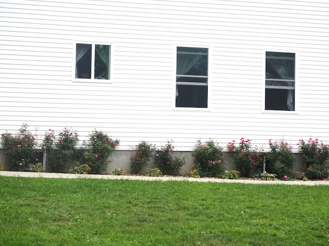 view of side of property with a lawn