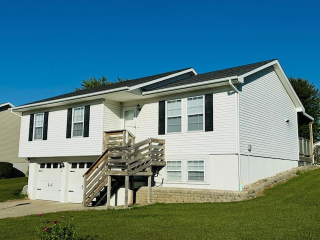 view of front of house with a front yard and a garage