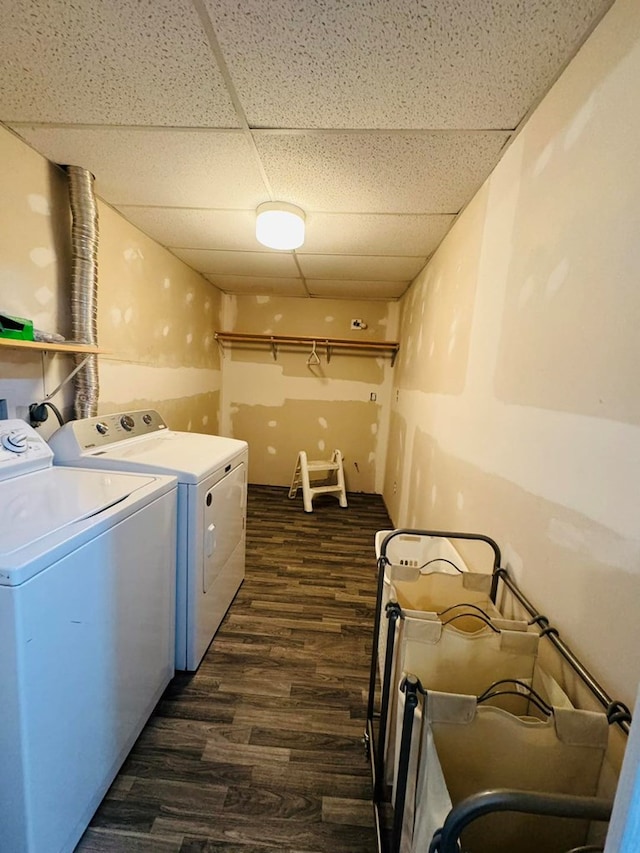 washroom with washer and clothes dryer and dark wood-type flooring